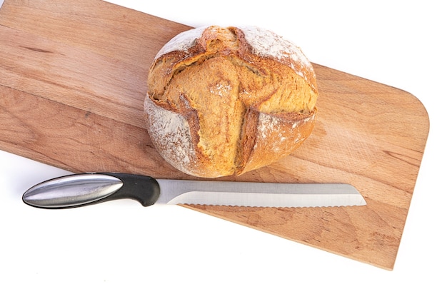 Traditional round bread with cutting board on a white background