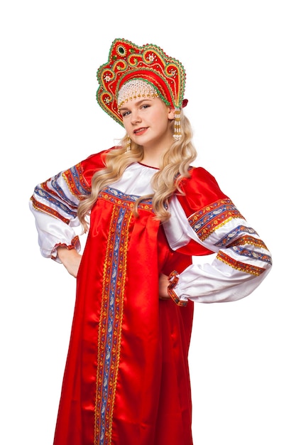 Traditional Russian folk costume portrait of a young beautiful blonde girl in red dress isolated on white background