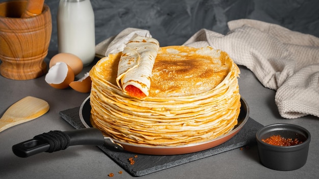 Traditional Russian pancakes with butter and red caviar