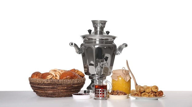 Traditional Russian samovar with treats isolated on white