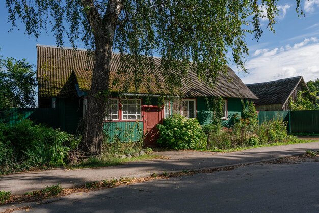 Traditional Russian wooden house on a sunny summer day Izborsk Pskov region Russia