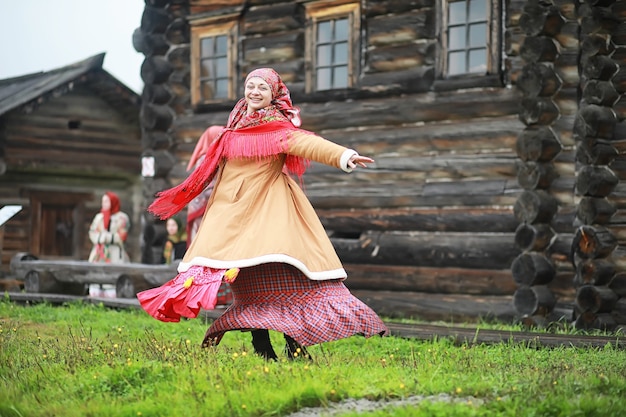 Traditional Slavic rituals in the rustic style. Outdoor in summer. Slavic village farm. Peasants in elegant robes.