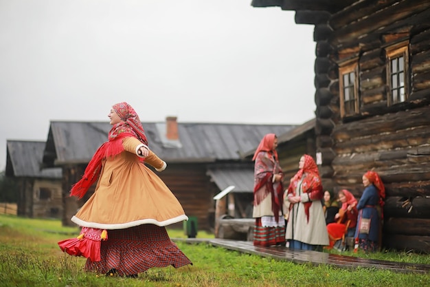 Traditional Slavic rituals in the rustic style Outdoor in summer Slavic village farm Peasants in elegant robes