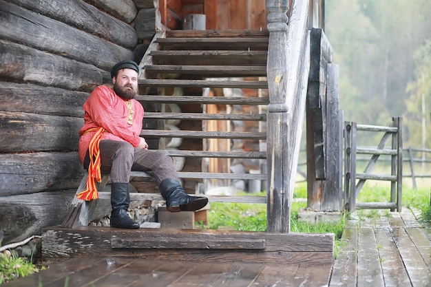 Traditional Slavic rituals in the rustic style Outdoor in summer Slavic village farm Peasants in elegant robes