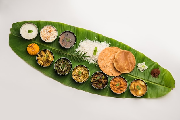 Traditional South Indian Meal or food served on big banana leaf, Food platter or complete thali.  selective focus