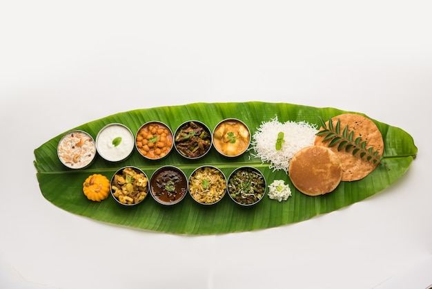 Traditional South Indian Meal or food served on big banana leaf, Food platter or complete thali.  selective focus