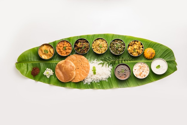 Traditional South Indian Meal or food served on big banana leaf, Food platter or complete thali.  selective focus