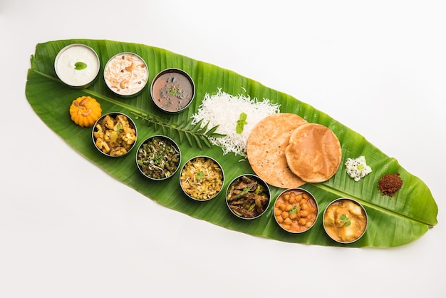 Traditional South Indian Meal or food served on big banana leaf, Food platter or complete thali.  selective focus