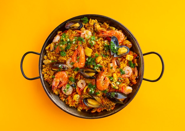 Traditional spanish seafood paella in the fry pan on a background