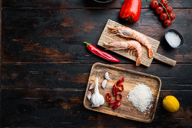 Traditional spanish seafood paella ingredients on old wooden dark table, top view with space for text, food photo.