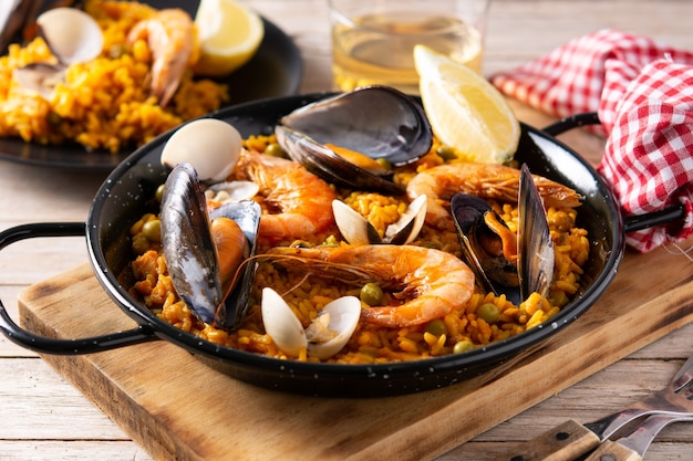 Traditional spanish seafood paella on wooden table