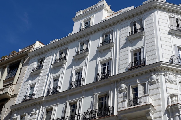 Traditional Spanish structure with windows and balconies with modernist architectural elements outside in Madrid Spain