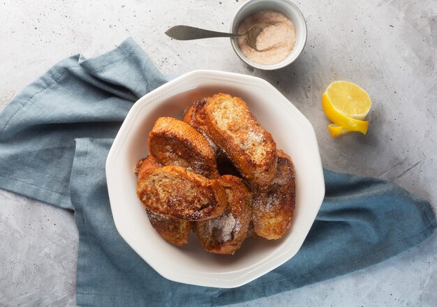 Traditional Spanish torrijas or French toast. Dessert for Christmas time or Pascua on a concrete background