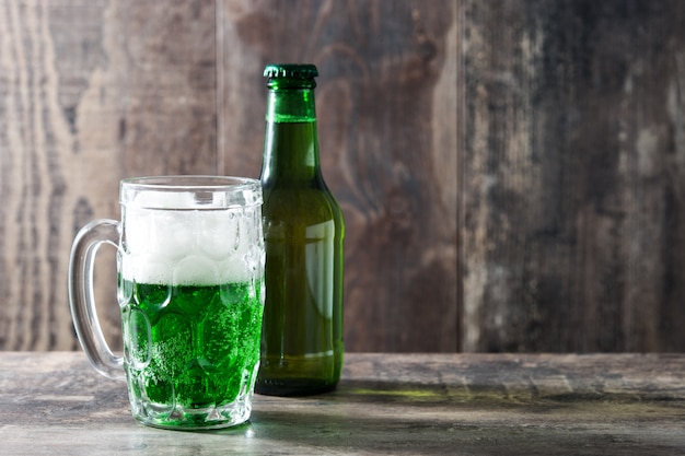 Traditional St Patrick's Day green beer on wooden table copy space