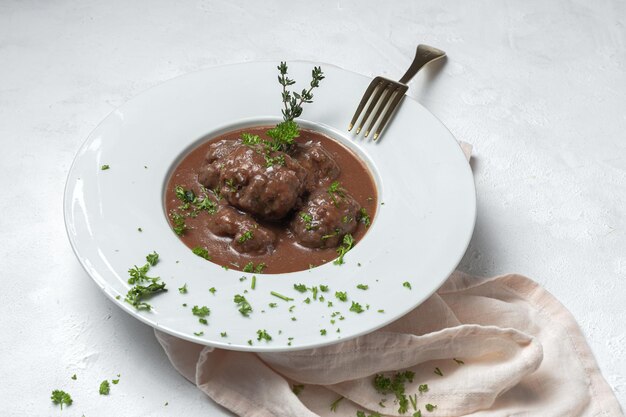 Traditional stew of homemade beef and lamb meatballs in tomato sauce and aromatic herbs. Typical Spanish food