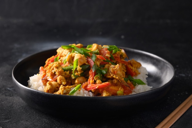 Traditional thai breakfast gai pad pongali with chicken eggs spicy yellow thai curry paste on rice