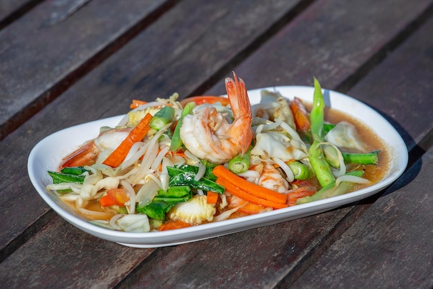 Traditional Thai spicy salad with shrimp in the restaurant close up