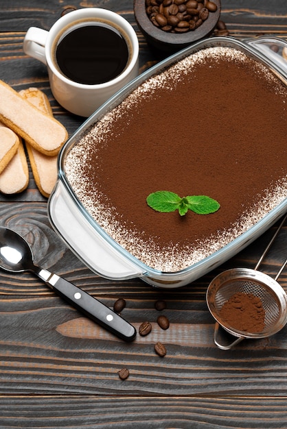 Traditional tiramisu dessert in glass baking dish