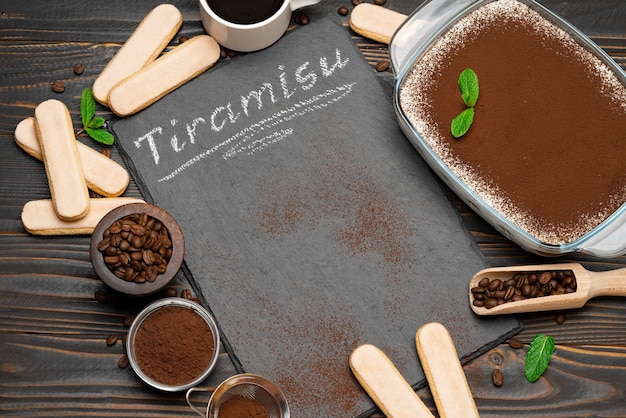 Traditional tiramisu dessert in a glass baking dish