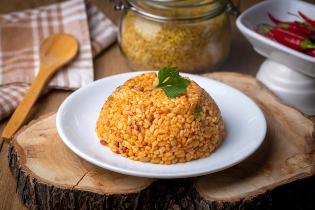 Traditional turkish bulgur pilaf with tomato sause in plate (Turkish name; meyhane pilavi)