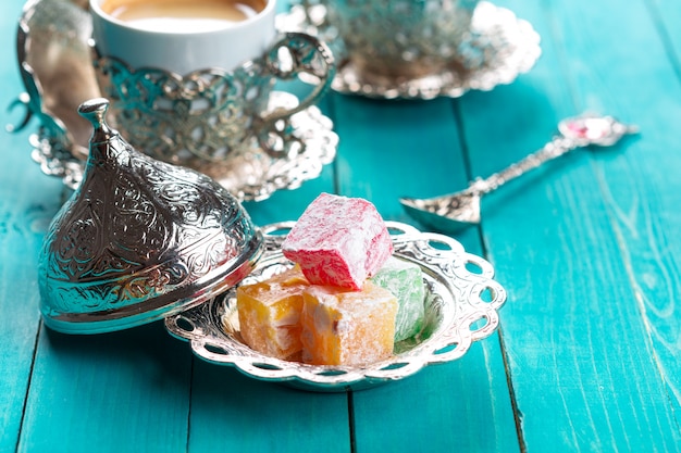 Traditional turkish coffee and turkish delight on wooden table.