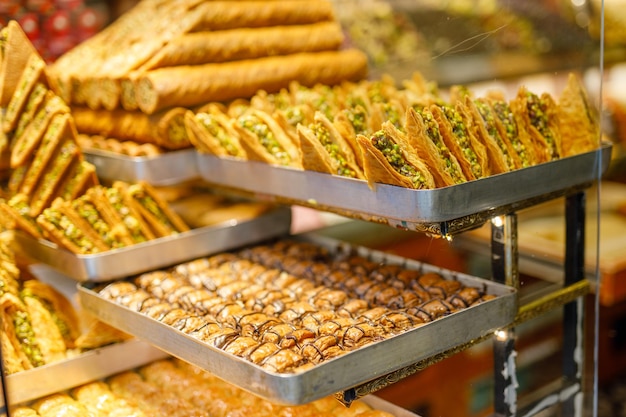 Traditional Turkish dessert Baklava closeup in the local Baklava shop Turkey Trays of delicious baklava displayed in showcase of baklavalari cafe