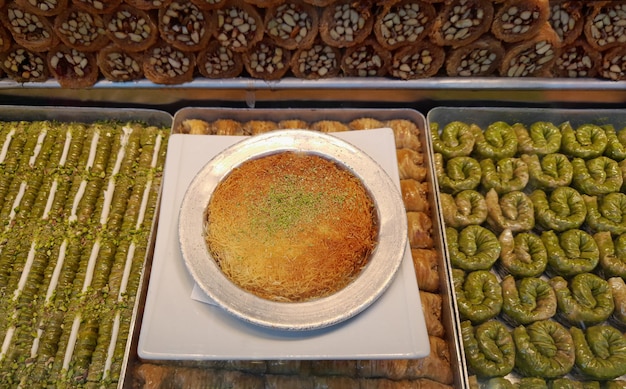 Traditional turkish desserts in the dessert shop window Baklava and Kunefe