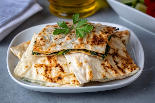 Traditional Turkish food, Turkish pancake gozleme with cheese and herb. The appetizer is Turkish pastry. There are varieties such as cheese, spinach, potato.