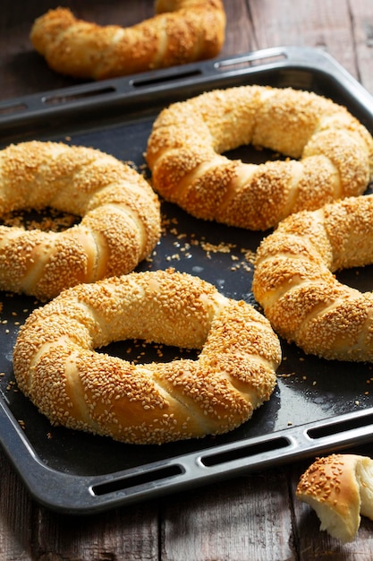 Traditional turkish simits with sesame seeds on a wooden background rustic style