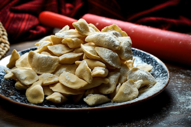 Traditional Ukrainian frozen dumplings with meat in a clay dish Ukrainian cuisine