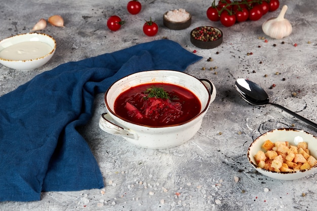 Traditional ukrainian red soup in a white bowl