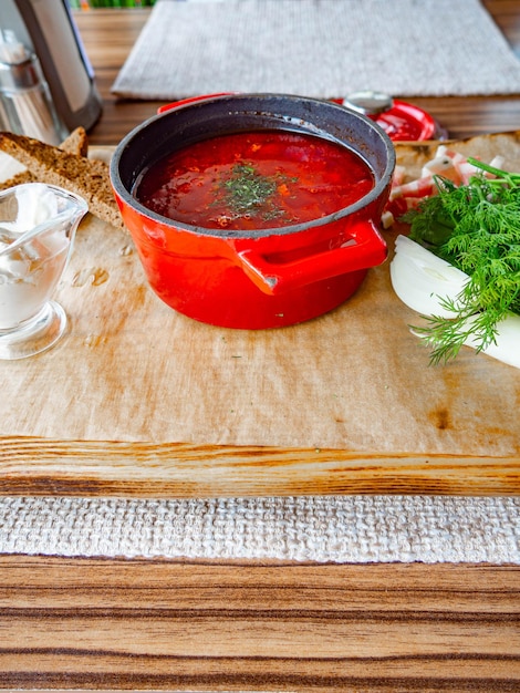 Traditional Ukrainian Russian borscht or red soup in the red pot