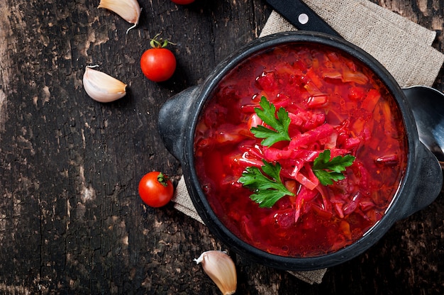 Traditional Ukrainian Russian vegetable borsch on the old wooden surface