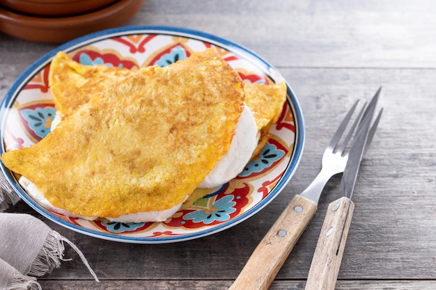 Traditional Venezuelan beef cachapa on wooden table