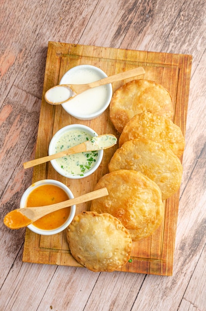 Traditional Venezuelan food basket accompanied by guasacas Rustic and wooden background