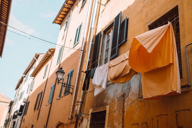 Traditional way of drying laundry in old facade build Pisa Italy