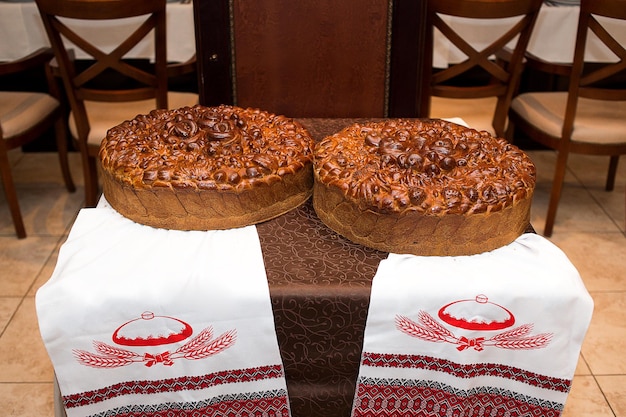 Traditional wedding Ukrainian bread Korovai and cake with flowers