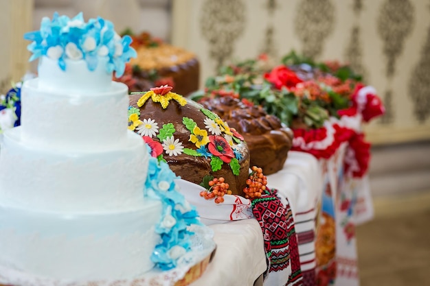 Traditional wedding Ukrainian bread Korovai and cake with flowers