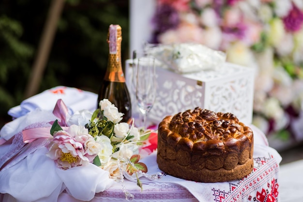 Traditional wedding Ukrainian bread Korovai and cake with flowers