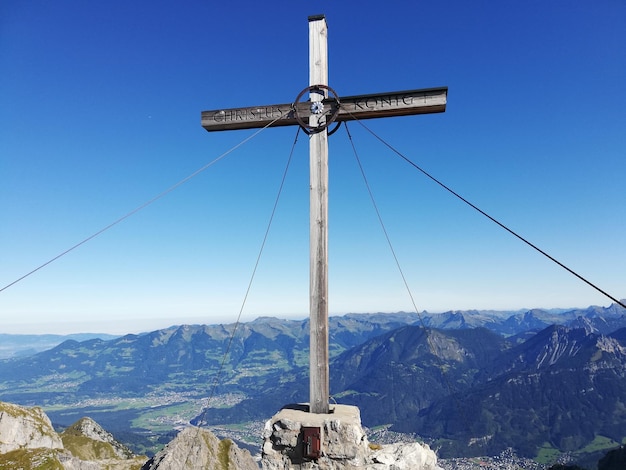 Photo traditional windmill on mountain against clear blue sky