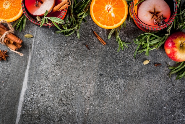 Traditional winter and autumn drinks. Christmas and Thanksgiving Cocktails. Mulled wine with orange, apple, rosemary, cinnamon and spices