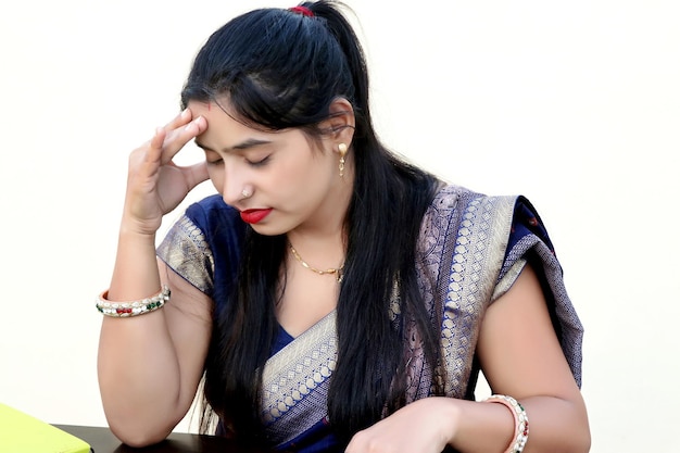 Traditional woman with headache holding her hands to the head