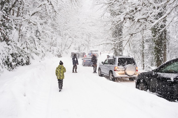 Traffic jam on a snowcovered slippery road road  Driving a car in extreme winter conditions