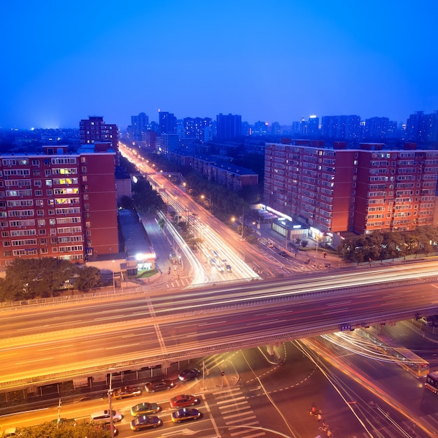 Traffic on junction at dusk in city