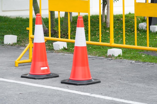 Traffic warning cone in row to separate route in parking area View of a Vehicle Security Barrier