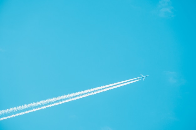 Trail of jet plane on blue sky