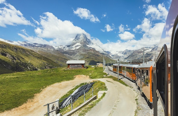 Train on the background of the Matterhorn mountain in the Swiss Alps