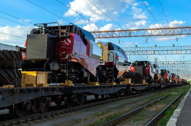 Train platform is loaded with new disassembled for transportation, agricultural, combines.