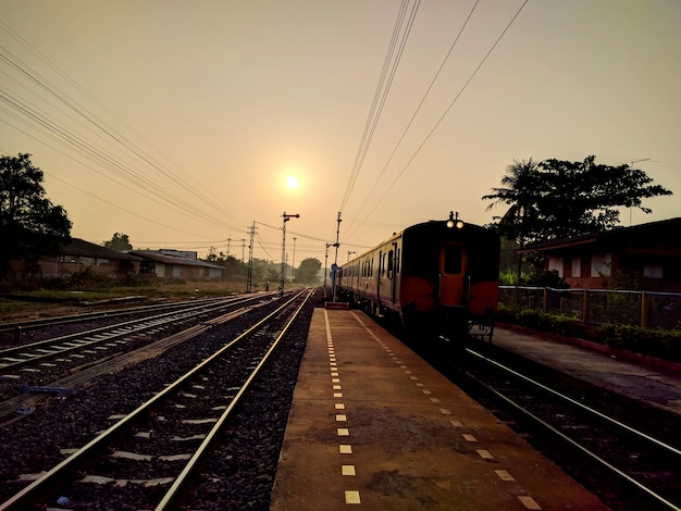 Train and railway station at sunset