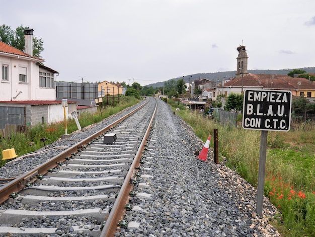 Train track at the exit of Monforte de Lemos towards Lugo and a sign next to the rails indicating quotBLAU single track automatic release blockade begins with CTC centralized traffic controlquot